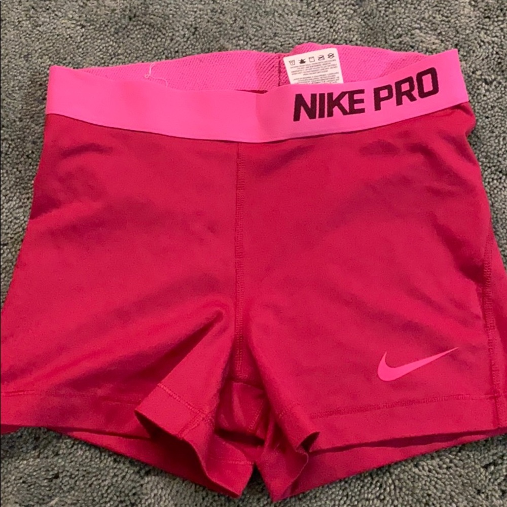 red and pink small nike pros